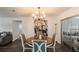 Elegant dining area features a chandelier, stylish chairs, and a large painting at 2070 Keyes Ln, Deltona, FL 32738
