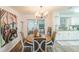 Dining room has open plan, hardwood floors, chandelier and contemporary art at 2070 Keyes Ln, Deltona, FL 32738