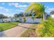 Cozy one-story home featuring a well-maintained lawn, attached garage, and tropical palm trees at 2070 Keyes Ln, Deltona, FL 32738
