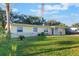 Lovely one-story home featuring a well-kept lawn, palm trees, and a convenient attached garage at 2070 Keyes Ln, Deltona, FL 32738