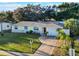 Inviting single-Gathering home with a bright red door, well-maintained lawn, and attached garage at 2070 Keyes Ln, Deltona, FL 32738
