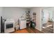 Clean laundry room featuring modern appliances, ample storage space and wood floors at 2070 Keyes Ln, Deltona, FL 32738
