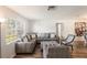 Bright living room featuring modern decor, wood floors, and large windows at 2070 Keyes Ln, Deltona, FL 32738
