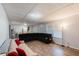 Spacious living room featuring wood floors, large windows and a comfortable oversized couch at 2070 Keyes Ln, Deltona, FL 32738