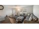 Inviting living room with neutral decor, wood floors, comfortable seating, and natural light at 2070 Keyes Ln, Deltona, FL 32738
