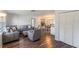 Bright living room featuring modern decor, wood floors, and an open concept layout at 2070 Keyes Ln, Deltona, FL 32738