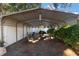 Covered outdoor patio with brick floor, seating, grill, and lush landscaping for relaxing and entertaining at 2070 Keyes Ln, Deltona, FL 32738