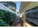 View of side yard with privacy bushes and small stones that go to the back yard at 2070 Keyes Ln, Deltona, FL 32738
