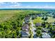 Aerial view of the home near a golf course and ponds in a neighborhood surrounded by trees at 2081 The Oaks Blvd, Kissimmee, FL 34746