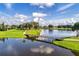 The aerial shot reveals a scenic view of the golf course, pond, and surrounding trees at 2081 The Oaks Blvd, Kissimmee, FL 34746