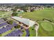 Overhead view of golf course clubhouse, parking, manicured lawn, and practice range at 2081 The Oaks Blvd, Kissimmee, FL 34746