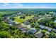 Aerial view of the home near a golf course and ponds in a neighborhood surrounded by trees at 2081 The Oaks Blvd, Kissimmee, FL 34746