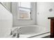Bathroom featuring a large soaking tub with chrome fixtures and tile surround at 2081 The Oaks Blvd, Kissimmee, FL 34746