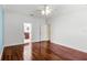 Bedroom features wood flooring, neutral walls, and adjacent bathroom access at 2081 The Oaks Blvd, Kissimmee, FL 34746