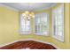 Bright dining room with hardwood floors, chandelier, and plantation shutters for natural light at 2081 The Oaks Blvd, Kissimmee, FL 34746