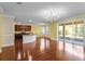 Open-concept kitchen and dining area with cherry wood cabinets, center island, and sliding glass doors to the patio at 2081 The Oaks Blvd, Kissimmee, FL 34746