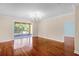 Living room with hardwood floors, sliding glass doors leading to screened lanai at 2081 The Oaks Blvd, Kissimmee, FL 34746