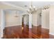 Spacious living room with hardwood floors, stairs, chandelier lighting, and classic architectural details at 2081 The Oaks Blvd, Kissimmee, FL 34746