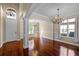 Elegant living room with hardwood floors, chandelier lighting, and classic architectural details at 2081 The Oaks Blvd, Kissimmee, FL 34746