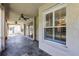 View of the covered lanai with tile floors, ceiling fans, and sliding glass doors to a screened patio at 2081 The Oaks Blvd, Kissimmee, FL 34746