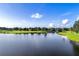 Scenic view of a lush green golf course, placid pond, and blue sky, offering a serene and picturesque landscape at 2081 The Oaks Blvd, Kissimmee, FL 34746