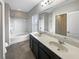 Bright bathroom with a double sink vanity and a shower-tub combo at 2124 Betsy Ross Ln, St Cloud, FL 34769
