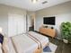 Spacious bedroom with a neutral palette, ample closet space, and modern furnishings with a TV at 2124 Betsy Ross Ln, St Cloud, FL 34769