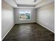 This bedroom features wood-look tile flooring and a large window providing plenty of natural light at 2124 Betsy Ross Ln, St Cloud, FL 34769