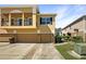 Three-story townhome featuring an attached garage and well-manicured landscaping at 2124 Betsy Ross Ln, St Cloud, FL 34769