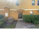 Inviting townhome with a dark front door, tidy landscaping and easy access walkway at 2124 Betsy Ross Ln, St Cloud, FL 34769