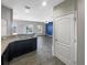 Kitchen with dark cabinets and breakfast bar leading to the living space at 2124 Betsy Ross Ln, St Cloud, FL 34769