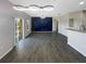 Open-concept living room and dining area with modern lighting and sliding glass doors to a balcony at 2124 Betsy Ross Ln, St Cloud, FL 34769