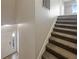 Carpeted stairs with white banister, near the front door and tiled foyer at 2124 Betsy Ross Ln, St Cloud, FL 34769