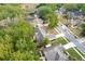 Overhead view of neighborhood houses with mature trees, manicured lawns, and a community pond nearby at 2132 Majestic Woods Blvd, Apopka, FL 32712