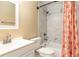 Bathroom featuring a white vanity, toilet, tub, tiled shower with a decorative curtain and good lighting at 2132 Majestic Woods Blvd, Apopka, FL 32712