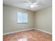 Comfortable bedroom with neutral walls, a ceiling fan, and ceramic tile flooring, offering a relaxing space at 2132 Majestic Woods Blvd, Apopka, FL 32712