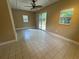 Bright bedroom with tile flooring, ceiling fan, and backyard access at 2132 Majestic Woods Blvd, Apopka, FL 32712