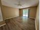Neutral bedroom with ceiling fan and sliding glass door to outdoor space at 2132 Majestic Woods Blvd, Apopka, FL 32712