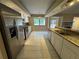Open kitchen features granite countertops and modern stainless steel appliances at 2132 Majestic Woods Blvd, Apopka, FL 32712