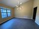 Bright living room featuring vaulted ceilings and modern light fixture at 2132 Majestic Woods Blvd, Apopka, FL 32712
