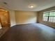 Spacious living room with large window and neutral color palette at 2132 Majestic Woods Blvd, Apopka, FL 32712