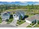Aerial view of the residential neighborhood showcasing well-maintained homes and beautiful green surroundings at 216 Miles Ct, Davenport, FL 33837