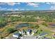 Aerial view of a neighborhood surrounded by wooded areas and wetlands at 216 Miles Ct, Davenport, FL 33837