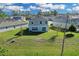 Spacious backyard with green grass, showing back of house with sliding doors at 216 Miles Ct, Davenport, FL 33837