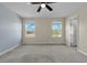 Spacious bedroom features two windows and a ceiling fan for added comfort at 216 Miles Ct, Davenport, FL 33837