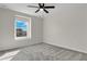 Neutral bedroom with a ceiling fan and a view from the window at 216 Miles Ct, Davenport, FL 33837