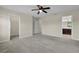 Neutral bedroom boasts a ceiling fan, carpet flooring, and access to the bathroom at 216 Miles Ct, Davenport, FL 33837