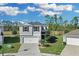 Charming two-story home featuring a two-car garage, well-manicured lawn, and lush landscaping at 216 Miles Ct, Davenport, FL 33837