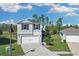 Charming two-story home featuring a two-car garage, well-manicured lawn, and lush landscaping at 216 Miles Ct, Davenport, FL 33837