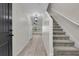 Inviting home foyer featuring wood-look tile flooring, a staircase, and modern light fixtures at 216 Miles Ct, Davenport, FL 33837